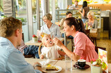 1019149_father-and-mother-feeding-child-cake-cafe_160